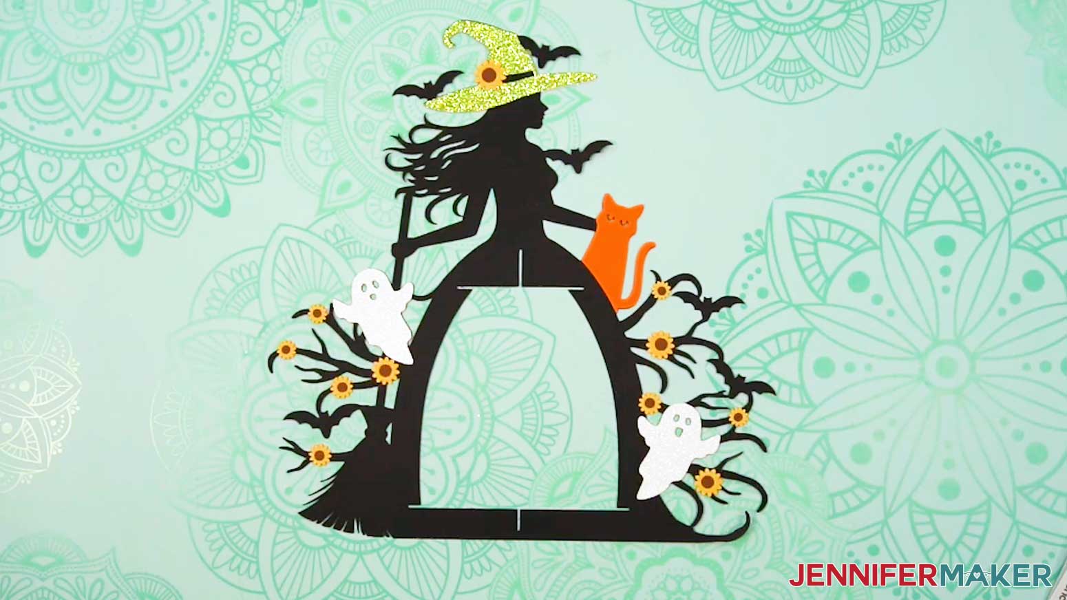 Add the decorative elements and flowers to the back of the witch frame.
