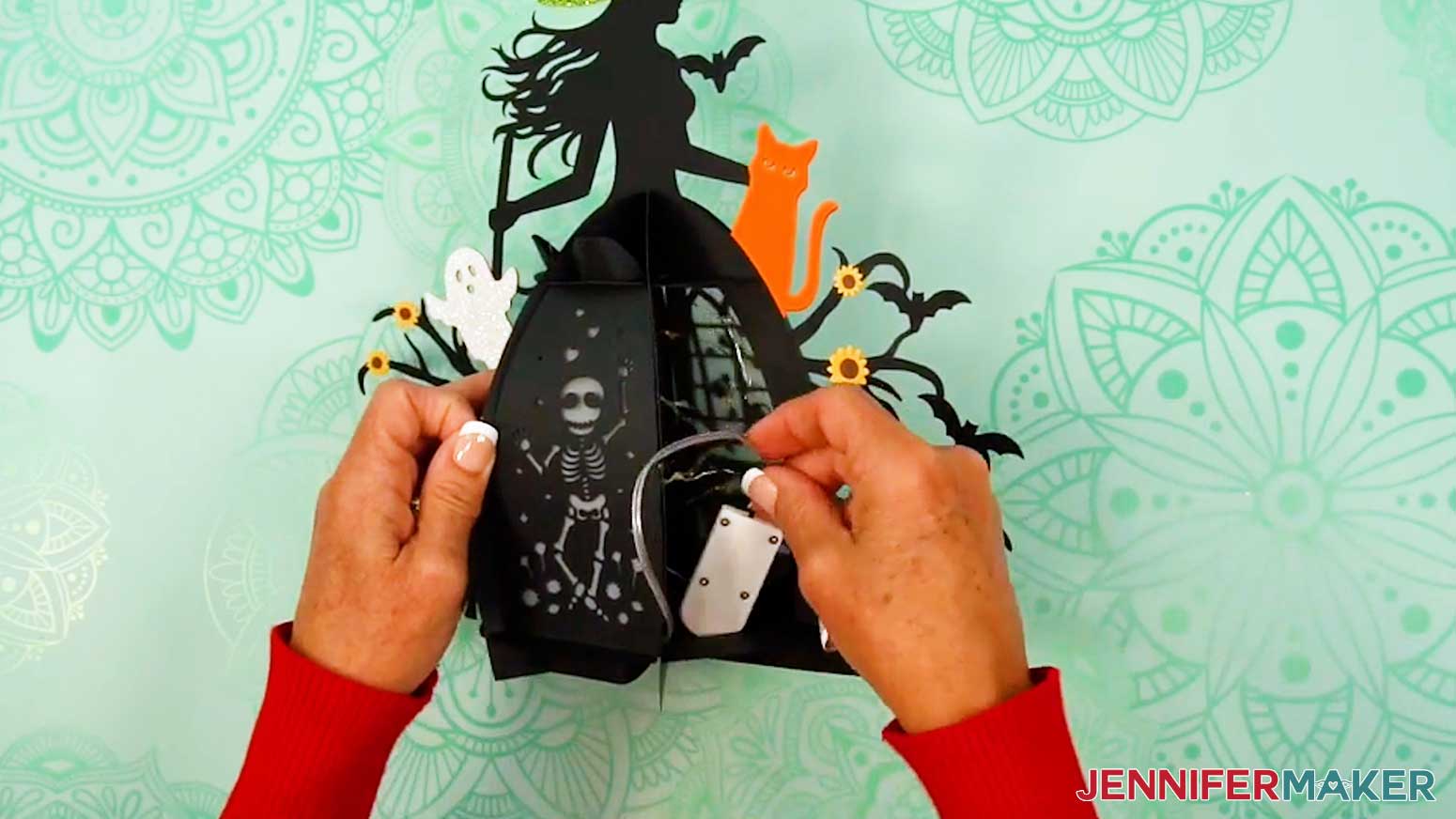 Place the coil of fairy lights and the battery pack inside the witch lantern.