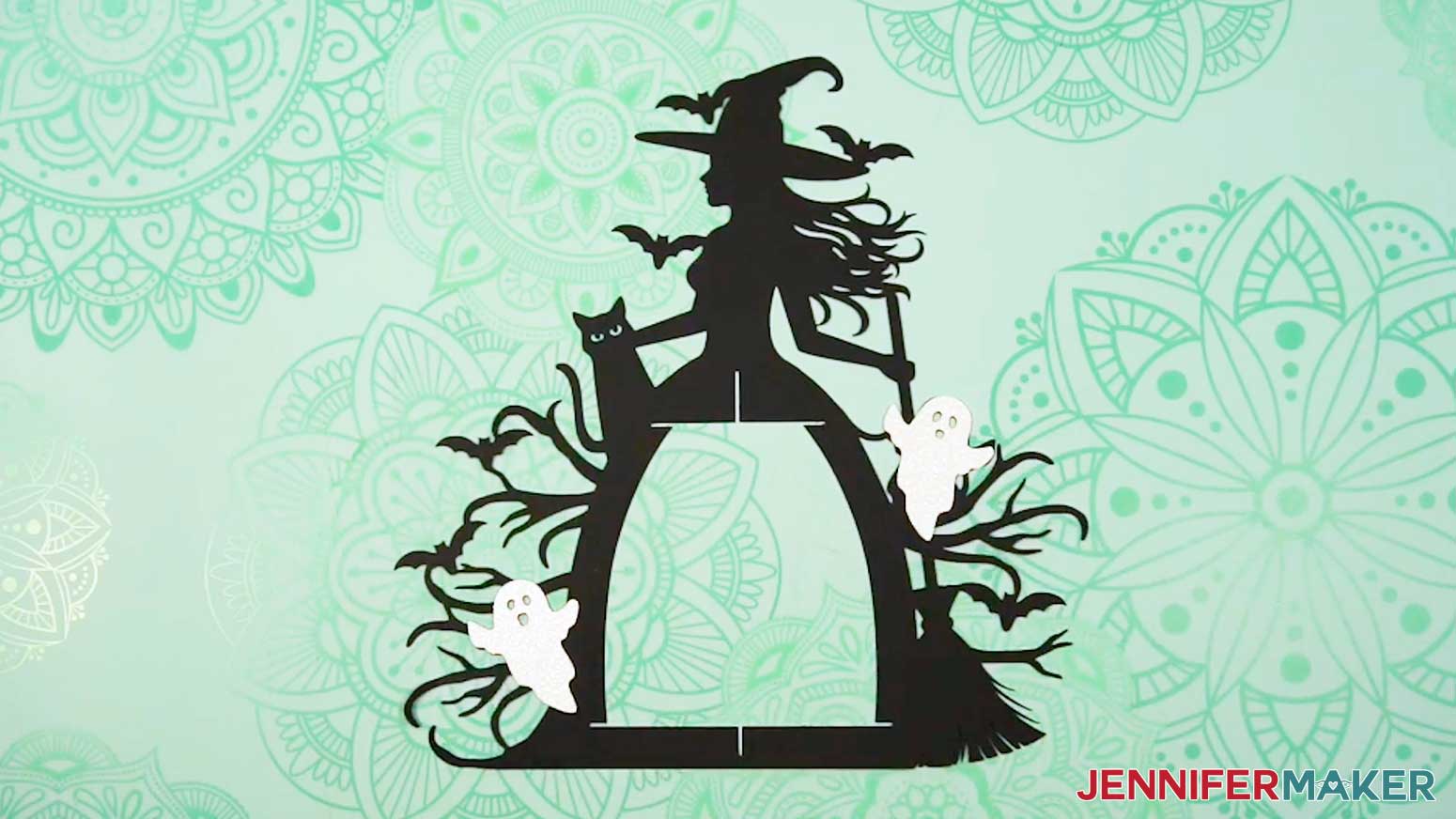 The two white ghost pieces placed onto the black witch frame.