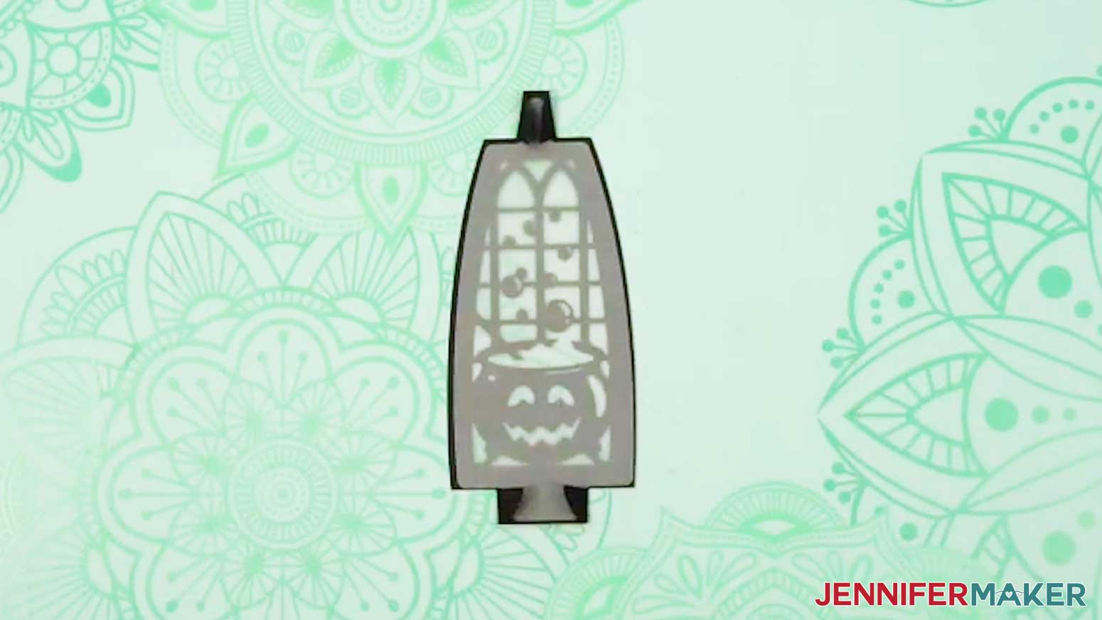 Insert a vellum diffuser piece onto the back of the folded witch lantern panel, using the wings to hold it in place.