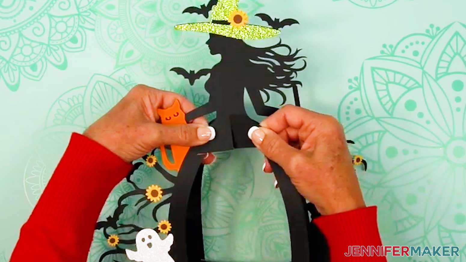 Lay the two frame pieces flat against each other, then slot them into the main witch frame piece.