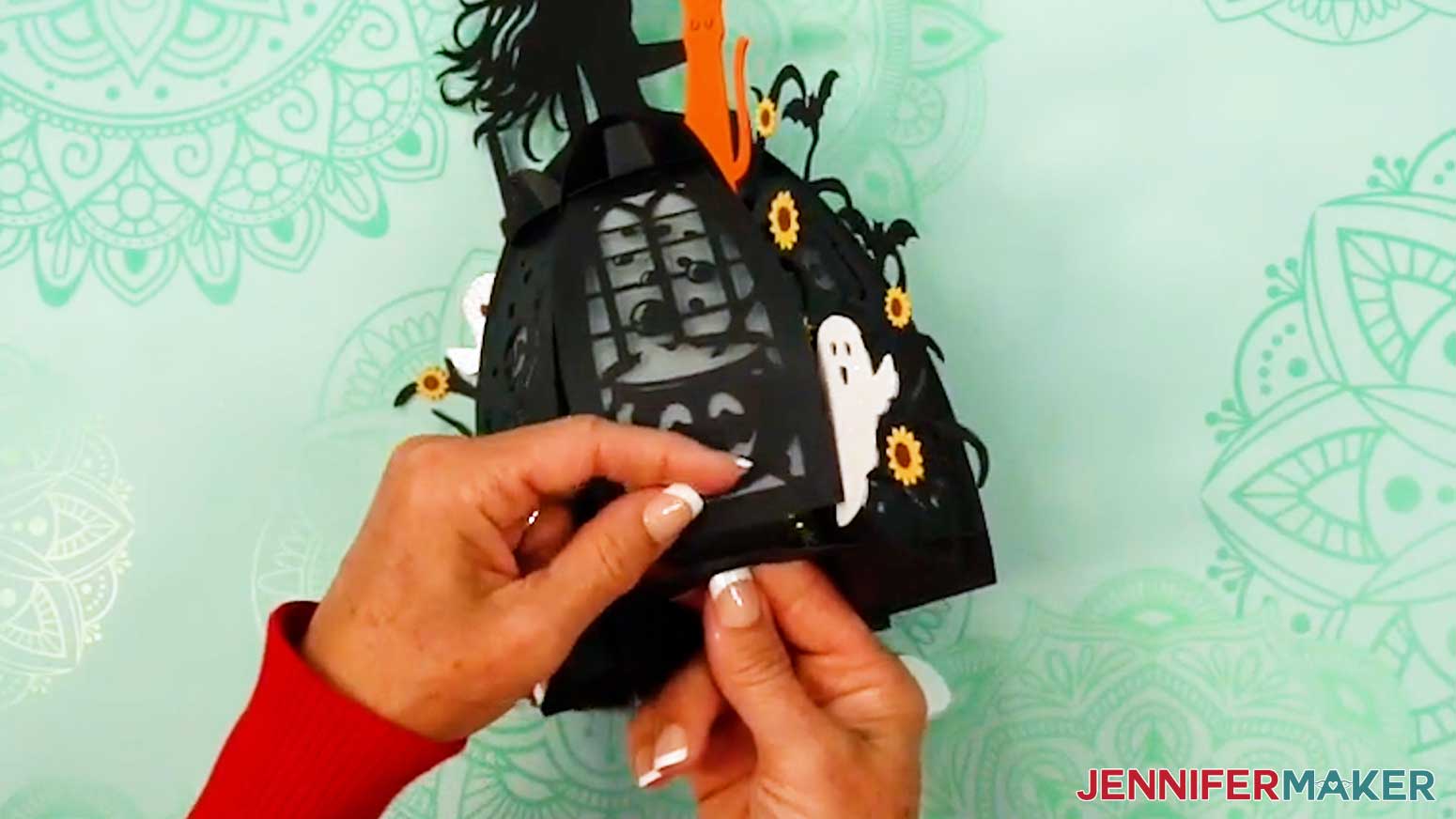 Slot the sixth and final panel into the witch lantern after the lights are inside.