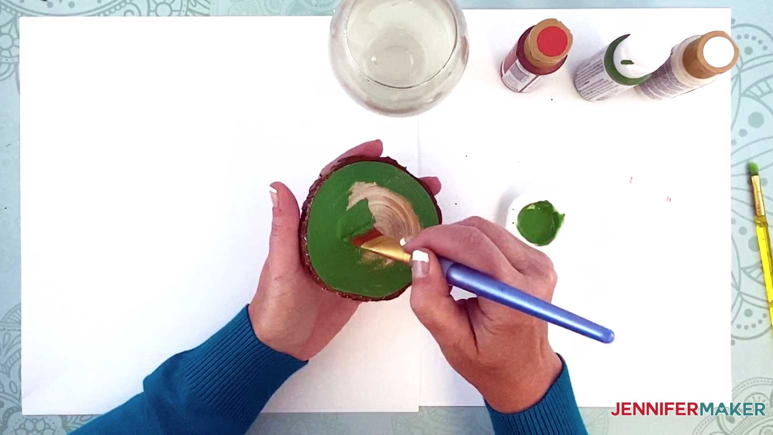 Use a larger brush to paint the middle of the wood slice ornament