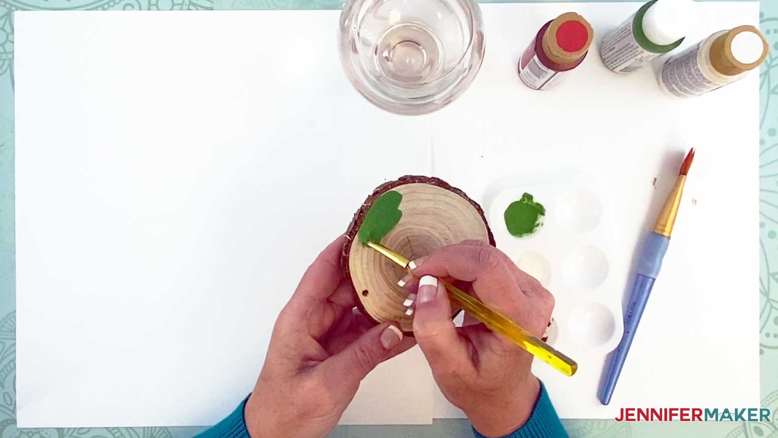 Use a small paint brush to paint around the edge of the wood slice ornament