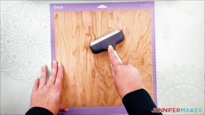 Use a brayer to flatten the veneer to the machine mat for my wooden bookmarks project